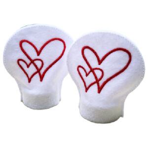 Set of two white felt LED tealight covers with embroidered red heart designs, shown side by side, designed to fit over tealight holders and create a soft decorative glow.