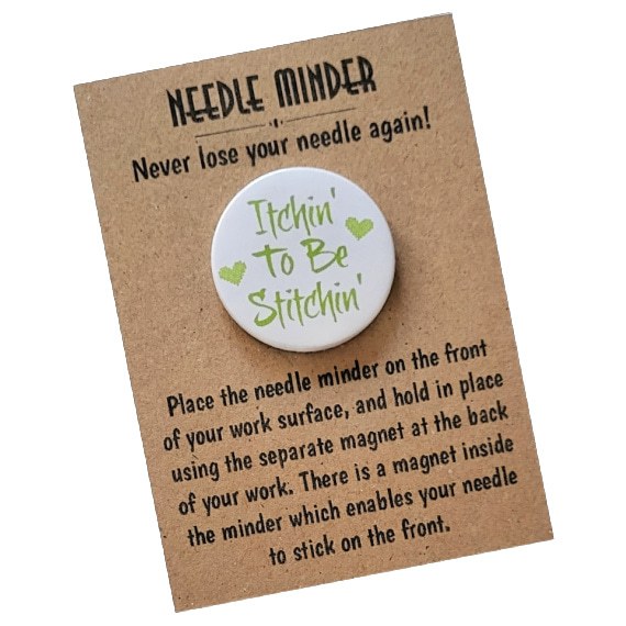 Round magnetic needle minder with lime green text that reads ‘Itchin’ To Be Stitchin’’ and two small green hearts, on a white background. Displayed on kraft card with instructions.