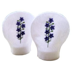 Set of two white felt tealight covers embroidered with purple larkspur flowers and green stems, designed to fit over standard LED tealights.