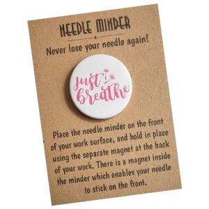 Just Breathe Needle Minder – circular magnetic sewing accessory featuring calming text and floral design. Displayed on brown kraft card backing.