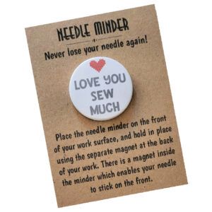 Round magnetic needle minder, white background with grey lettering that says ‘Love You Sew Much,’ and a stitched-style red heart in the centre. Presented on kraft card.