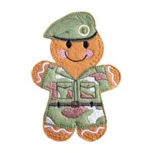 Handmade felt Military Camouflage Gingerbread Character in a camouflage uniform with stitched pockets, belt, and a matching beret featuring an embroidered badge. A cheerful smile adds warmth to this tribute keepsake