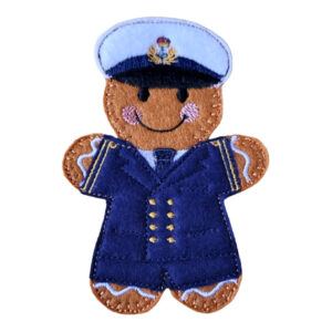 Naval Officer Gingerbread Character made from felt, dressed in a navy-blue uniform with gold buttons, rank stripes, and a white peaked cap with insignia, a whimsical embroidered keepsake available as a magnet, hanging decoration, keyring, or plain token.