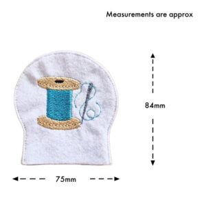 Embroidered needle and thread tealight cover made from white felt, showing approximate size of 84mm tall by 75mm wide, featuring a spool of thread and stitched detail.