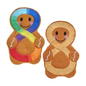Pair of handmade felt Neurodiversity Awareness Gingerbread Characters with smiling faces, one featuring a colourful rainbow infinity symbol and the other a gold infinity symbol, symbolising neurodiversity and autism awareness.