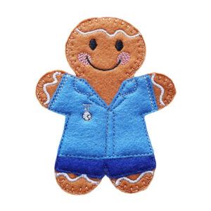 A handmade felt nurse gingerbread character with embroidered black eyes, a smiling mouth, pink cheeks, and icing-style stitching. The figure is dressed in blue scrub trousers and tunic with a tiny embroidered fob watch on the chest, displayed on a clean white background.