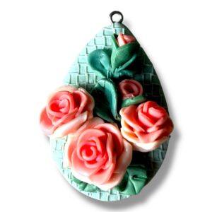 Handmade polymer clay rose pendant with coral pink gradient roses on textured sage green brick background, sculpted 3D floral statement necklace made in Sheffield.