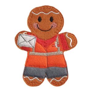 Felt gingerbread postal worker character wearing an orange hi-vis, red shirt, and grey trousers, holding a stitched envelope and smiling with embroidered details.