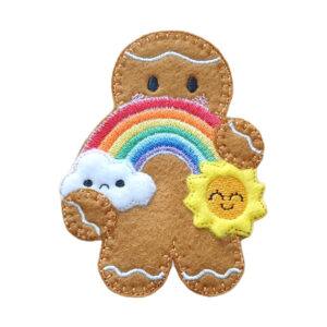 Rainbow & Sunshine Gingerbread Character — a cheerful felt gingerbread figure featuring a vibrant embroidered rainbow that connects a sad cloud and a smiling sun, symbolising hope, joy, and brighter days ahead. Crafted from soft felt with premium stitching, this whimsical handmade decoration spreads positivity and warmth.