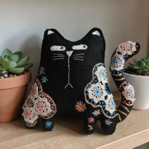 Made to order.Black cat decoration. Hand embroidered with vintage, crocheted lace fabric.Filled with lavender. All proceeds to The Stroke Association .