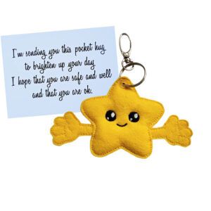 Star Pocket Hug Charm – A handmade yellow felt star with a smiling face and outstretched arms, attached to a keyring. Comes with a keepsake card that reads: ‘I’m sending you this pocket hug to brighten up your day. I hope that you are safe and well and that you are ok.’