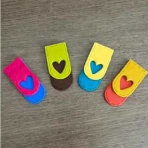 Colourful handmade polymer clay bookmarks with heart cut-out detail in mustard and burnt orange, lemon yellow and turquoise, lime green and chocolate, and hot pink with cobalt blue, designed to clip over book pages.