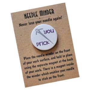 Round needle minder badge with a grey needle illustration and the cheeky text ‘you prick’ in purple letters. The badge is attached to a kraft card backing that reads ‘Needle Minder – Never lose your needle again!’ along with usage instructions.