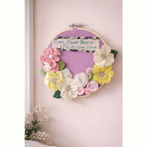 Felt Flower adorned Embroidery Hoop Art with caption ‘Every flower blooms in its own time.’