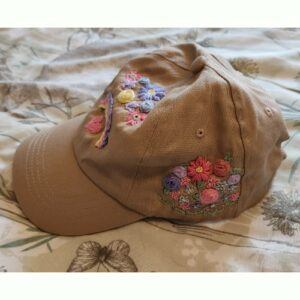 Ladies Beige Baseball Cap with hand embroidered flowers and rainbow