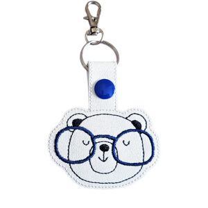 Bear face keyring with glasses made from faux leather, shown with matching keepsake card and metal keyring clasp.