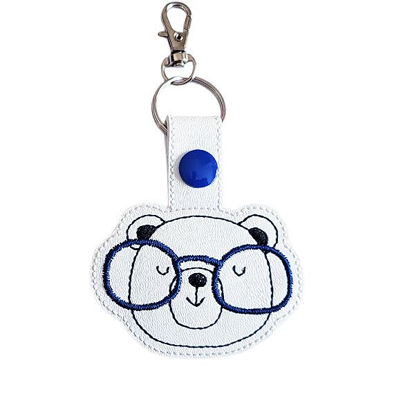 Bear face keyring with glasses made from faux leather, shown with matching keepsake card and metal keyring clasp.