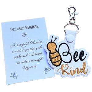 Bee Kind embroidered faux leather keyring with bee design, silver clasp and a white keepsake card with a kindness message.