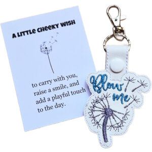 Cheeky embroidered dandelion faux leather keyring with teal text, silver clasp, and a white keepsake card with a playful message.