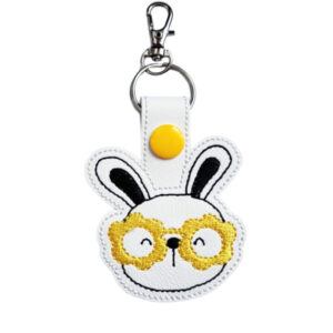 Bunny face keyring with yellow glasses, made from white faux leather with a metal split ring and swivel clasp.