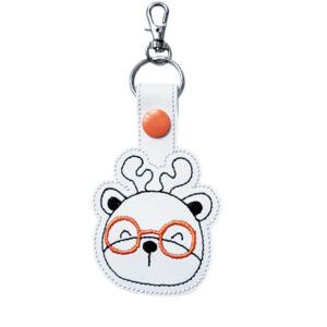 Deer face keyring with orange glasses, made from white faux leather with a metal split ring and swivel clasp.