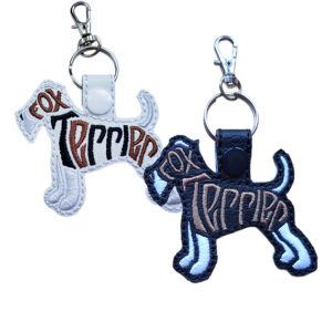 Embroidered Fox Terrier word art keyrings in black and white faux leather, featuring stitched dog silhouette design with split ring and clasp
