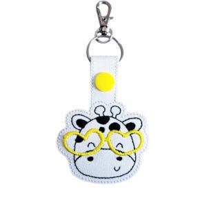 Giraffe face keyring with yellow glasses, made from white faux leather with a metal split ring and swivel clasp.