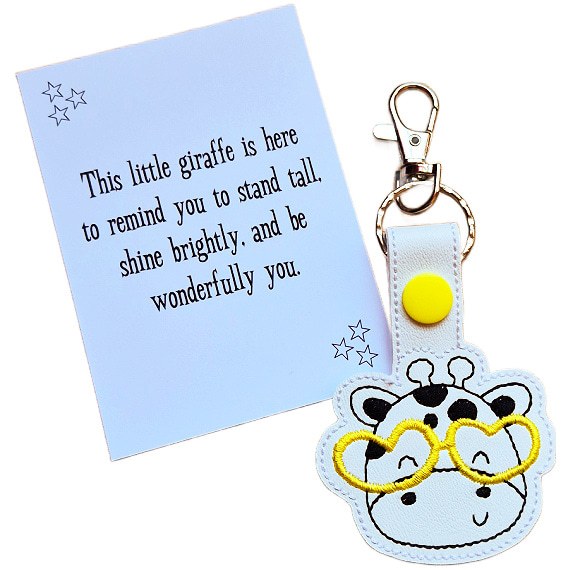 Giraffe face keyring with yellow glasses shown with matching keepsake card featuring an uplifting message.