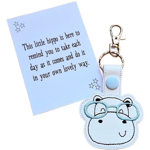 Hippo face keyring with blue glasses shown with matching keepsake card featuring an uplifting message.