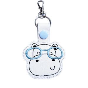 Hippo face keyring with blue glasses, made from white faux leather with a metal split ring and swivel clasp.