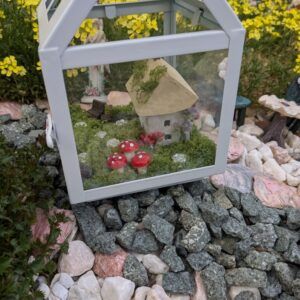 Fairy garden scene inside a hanging candle lantern