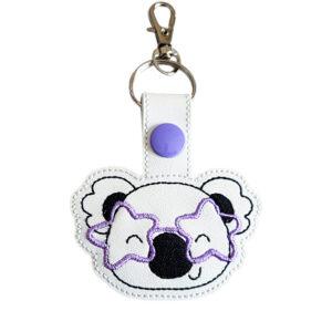 Koala face keyring with pink star glasses, made from white faux leather with a metal split ring and swivel clasp.