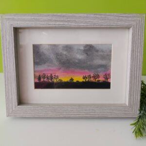 Original oil pastel painting of a sunrise under a moody grey sky with black silhouetted trees