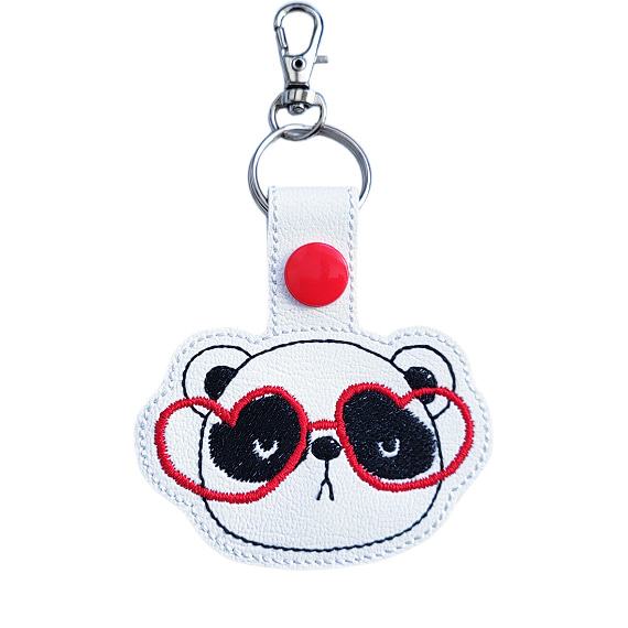 Panda face keyring with red heart glasses, made from white faux leather with a metal split ring and swivel clasp.