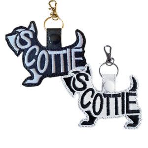 Embroidered Scottie word art keyrings in black and white faux leather, featuring stitched dog silhouette design with split ring and lobster clasp