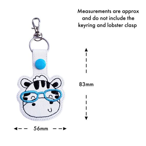 Zebra face keyring with glasses size guide, showing approximate measurements of 83mm high by 56mm wide.