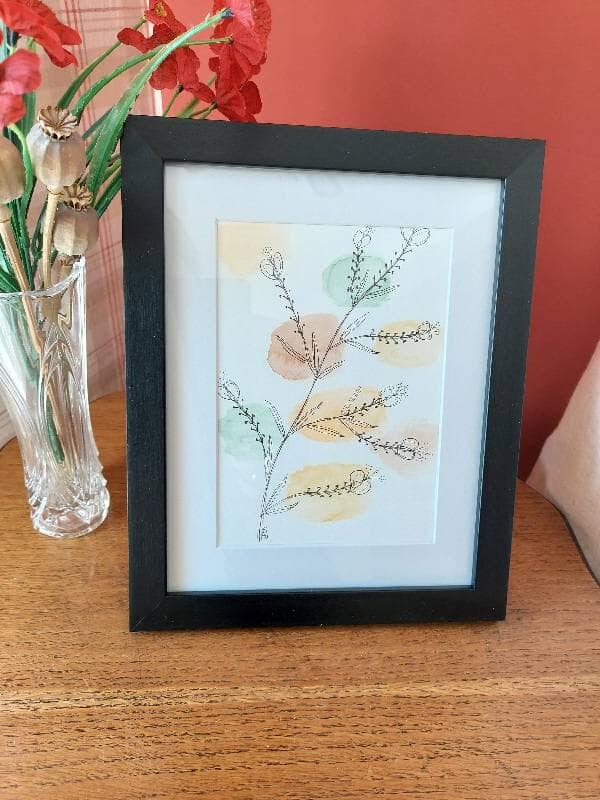 Framed mixed media floral illustration with coloured circle background with botanical sprig