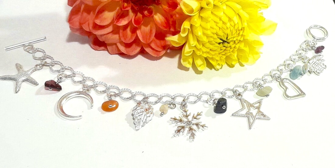 silver plated chakra charm bracelet with swarovski snowflake