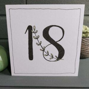 white 5" x 5" 18th birthday card. Black 18 with leaf stem feature