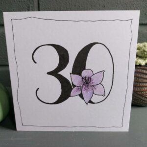 white 5" x 5" 30th birthday card. Black 30 with floral feature