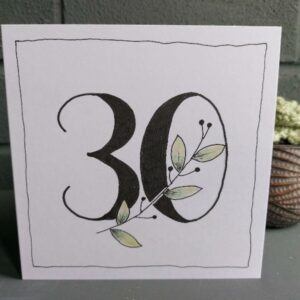 white 5" x 5" 30th birthday card. Black 30 with botanical stem feature