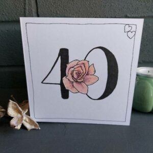 40th wedding anniversary card with bold number 40 and a pinky red rose nestled into the number