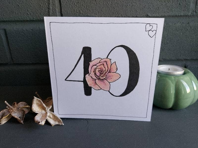40th wedding anniversary card with bold number 40 and a pinky red rose nestled into the number