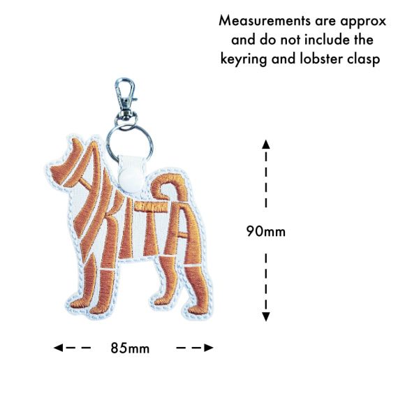White embroidered Akita word art keyring size guide showing approximate measurements of 90mm high by 85mm wide, excluding the keyring and lobster clasp.