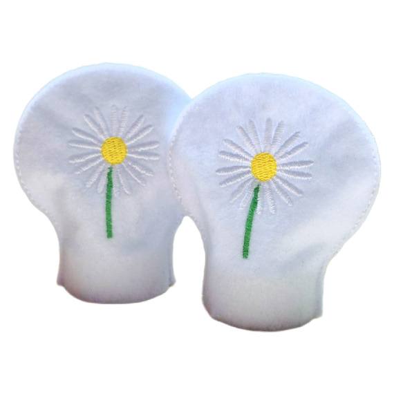 Unlit embroidered April birth flower tealight covers on white felt, with white daisies, yellow centres and green stems, designed to fit over battery operated LED tealights.