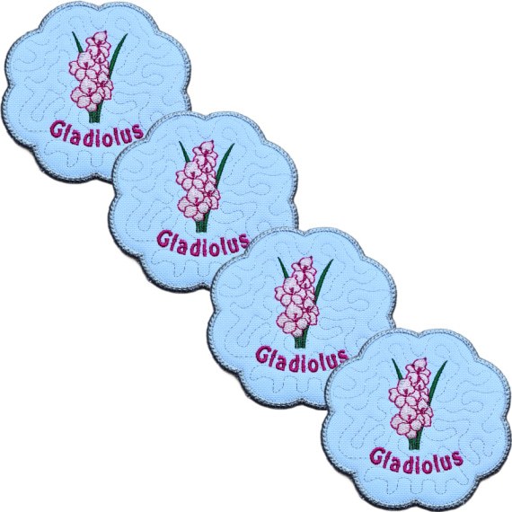 Set of four embroidered August birth flower candle coasters, each with pink gladiolus blooms, stitched gladiolus text, background detail and a scalloped silver border.