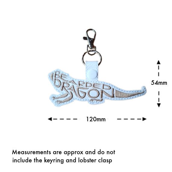 White faux leather bearded dragon word art keyring with size guide showing approximate measurements of 54mm x 120mm, excluding the keyring and lobster clasp.