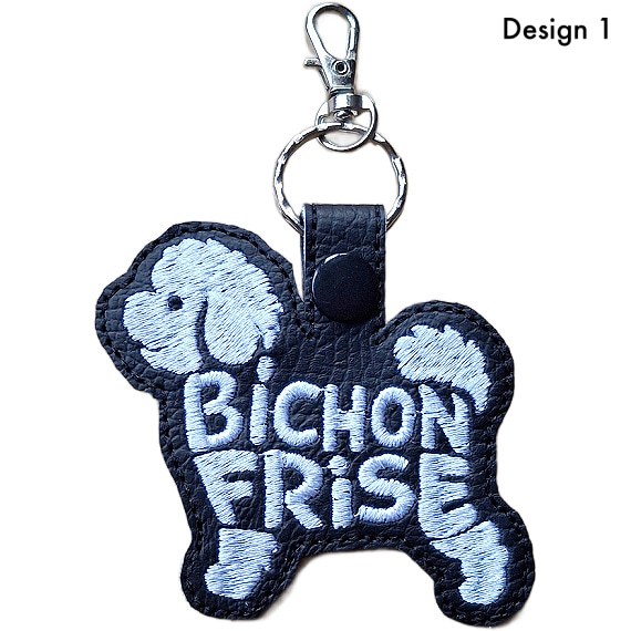 Black faux leather Bichon Frise word art keyring, Design 1, with white embroidered lettering, black snap fastener and silver clip.