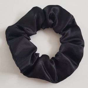 Black satin scrunchie on a light background, glossy fabric hair tie.