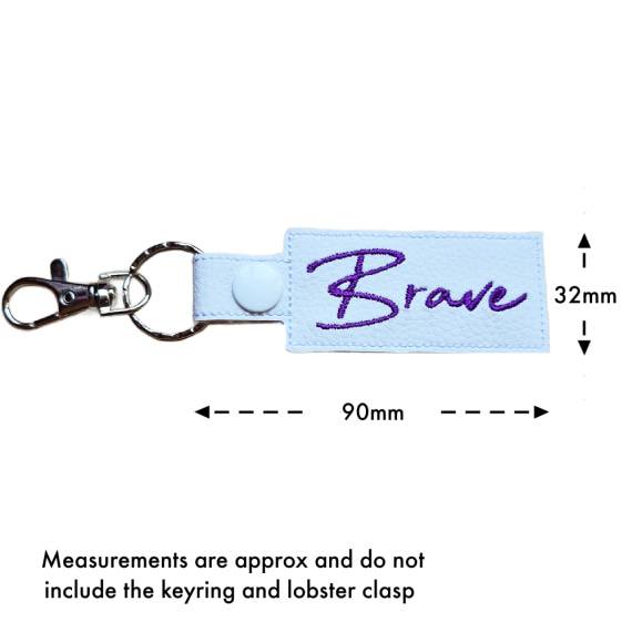Embroidered Brave keyring with size guide showing approximate measurements of 90mm by 32mm excluding the keyring and lobster clasp.